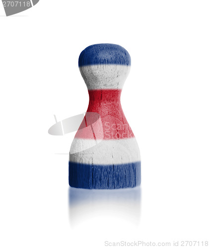 Image of Wooden pawn with a painting of a flag