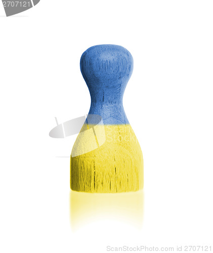 Image of Wooden pawn with a painting of a flag