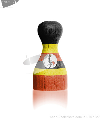 Image of Wooden pawn with a painting of a flag