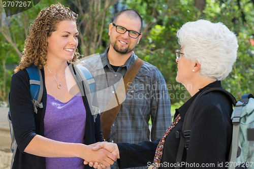 Image of Students Shaking Hands At University Campus