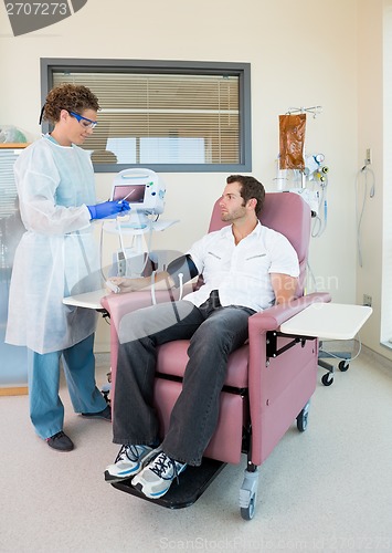 Image of Nurse Examining Patient's Pulse Rate In Chemo Room
