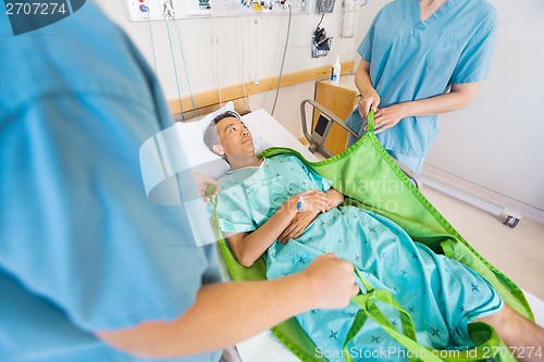 Image of Nurses Preparing Mature Patient Before Transferring Him On Hydra