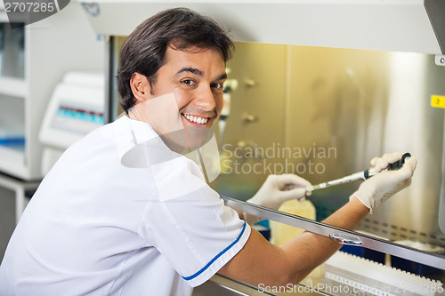 Image of Male Technician Experimenting In Laboratory