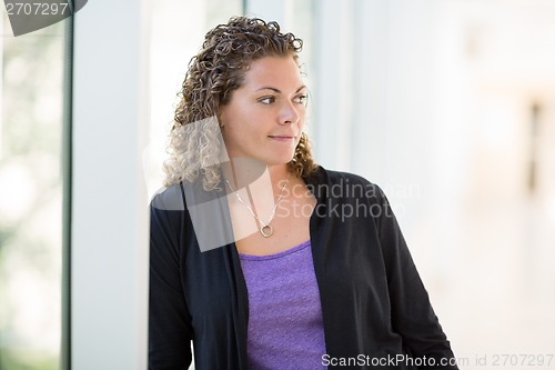 Image of Thoughtful Female Student At University Corridor