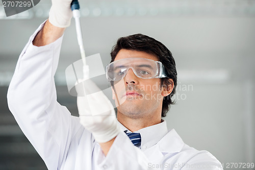 Image of Researcher Filling Solution Into Test Tube