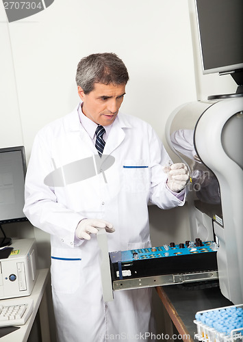 Image of Scientist Loading Analyzer With Samples