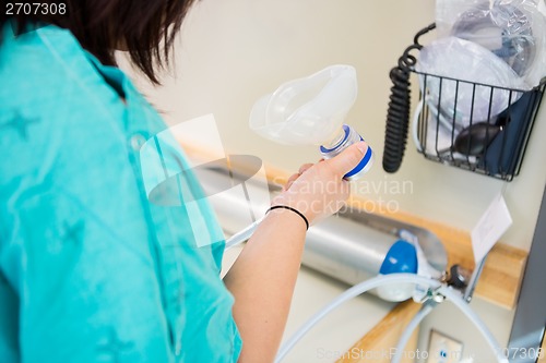 Image of Pregnant Woman Holding Nitrous Oxide Mask