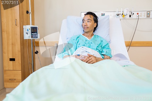 Image of Patient Reclining On Bed While Looking Away In Hospital