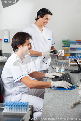 Image of Technicians Scanning Sample With Barcode Reader