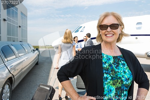 Image of Happy Businesswoman Against Private Jet