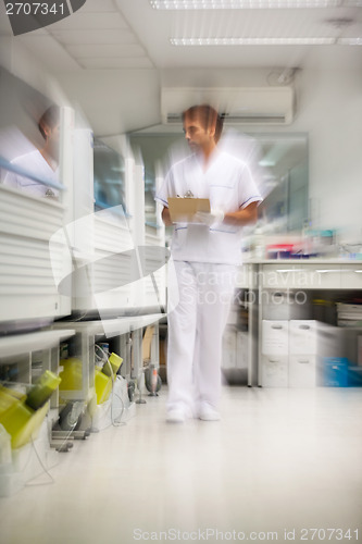 Image of Technician Walking In Storage Room