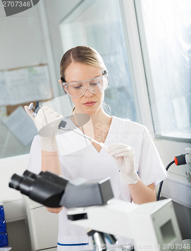 Image of Researcher Filling Liquid Into Test Tube