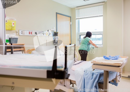 Image of Pregnant Woman At Window In Hospital Room