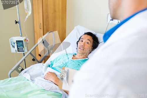 Image of Patient Looking At Doctor While Lying On Bed In Hospital