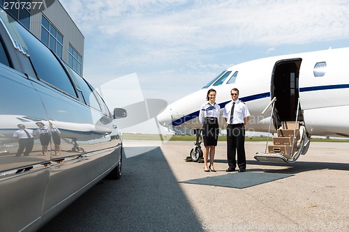 Image of Flight Attendant And Pilot Neat Limousine And Private Jet