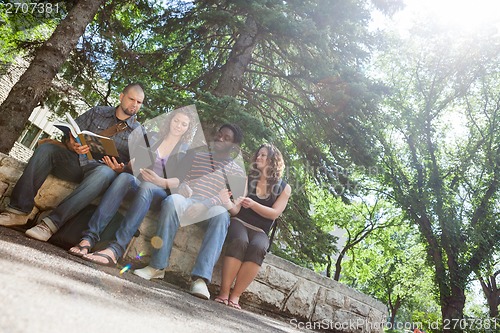 Image of Students Studying On Parapet At University Campus