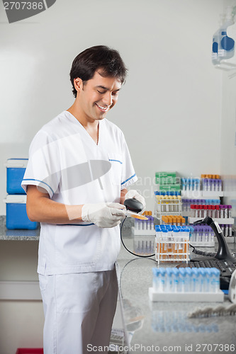 Image of Man Scanning Barcode On Specimen