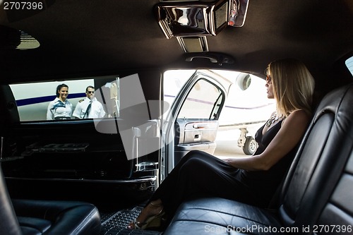 Image of Elegant Woman In Limousine At Airport Terminal