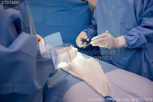 Image of Surgeons Operating Patient