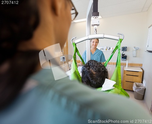 Image of Nurse Smiling With Patient On Hydraulic Lift