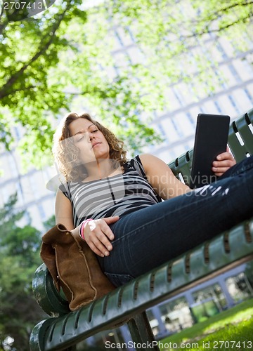 Image of University Student Using Digital Tablet On Bench