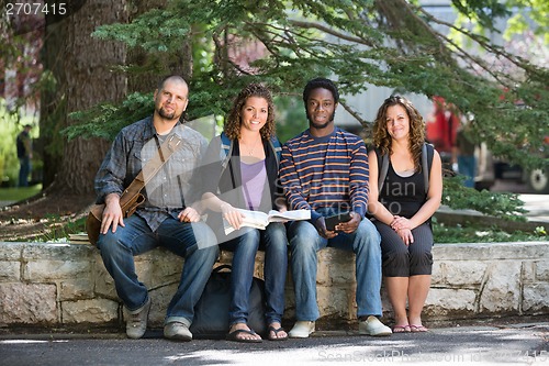 Image of Portrait Of University Students Sitting On Campus