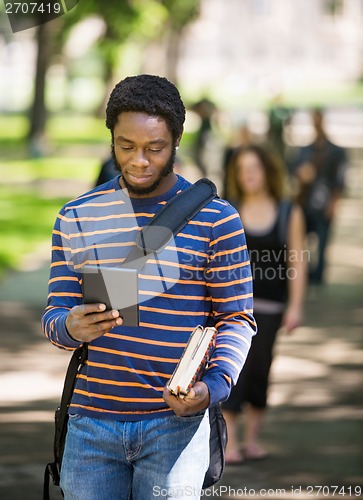 Image of Student Using Digital Tablet On Campus