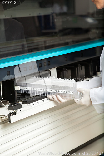 Image of Technician Placing Samples In Analyzer