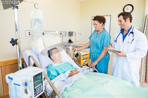 Image of Patient Looking At Medical Team In Hospital Room
