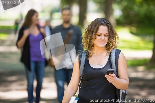 Image of Female Student Using Cellphone On Campus