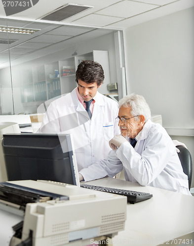 Image of Technicians Discussing Over Computer