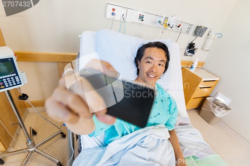 Image of Patient Taking Self Portrait Through Cell Phone In Hospital