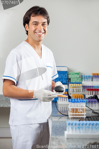 Image of Man Scanning Medical Sample In Laboratory