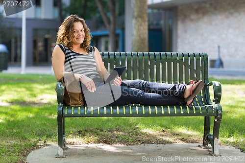 Image of Female University Student Relaxing On Bench