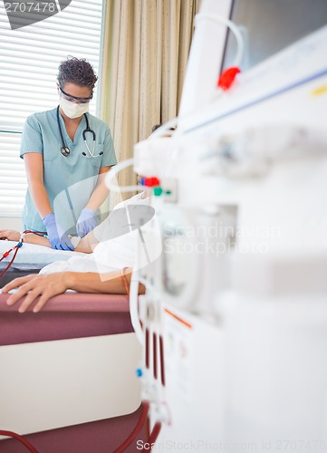 Image of Nurse Giving Renal Dialysis Treatment To Patient