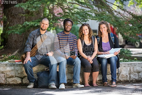 Image of University Students Sitting On Parapet At Campus