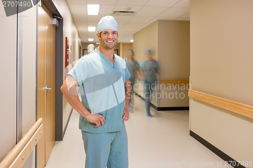 Image of Surgeon With Team Walking At Hospital Corridor