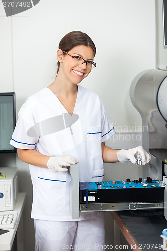 Image of Researcher Loading Solutions Into Analyzer