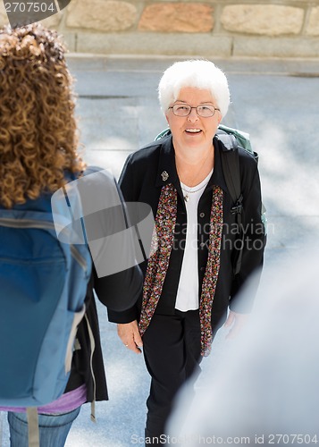 Image of College Professor Walking to Class Outdoors