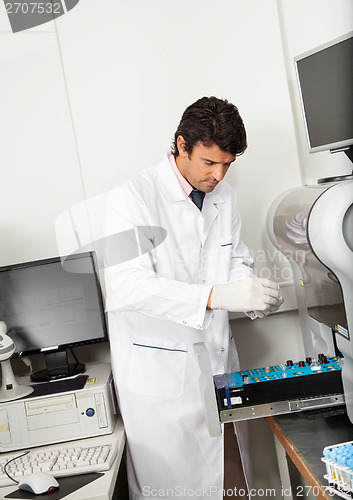 Image of Scientist Loading Analyzer With Samples