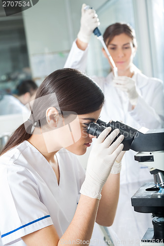 Image of Female Researcher Using Microscope