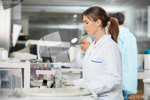 Image of Mecial Research Tech Using Centrifuge