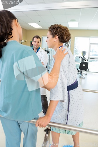 Image of Physical Therapist Assisting Female Patient In Walking