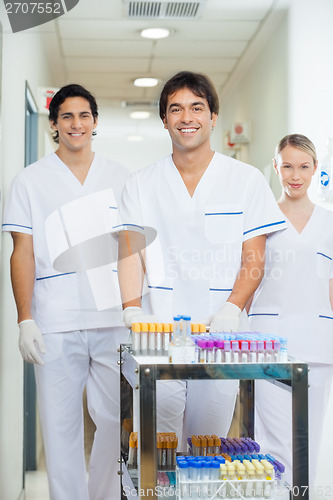 Image of Technicians With Medical Cart In Hospital Corridor