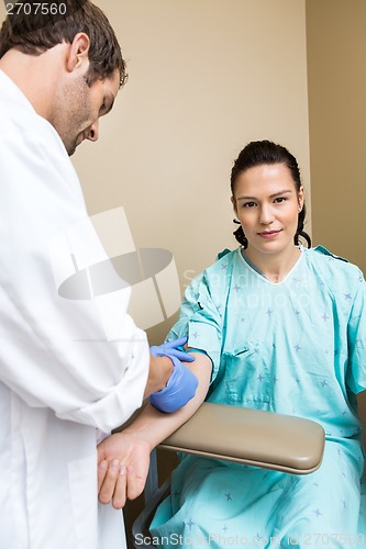 Image of Patient With Doctor Drawing Blood From Her Arm