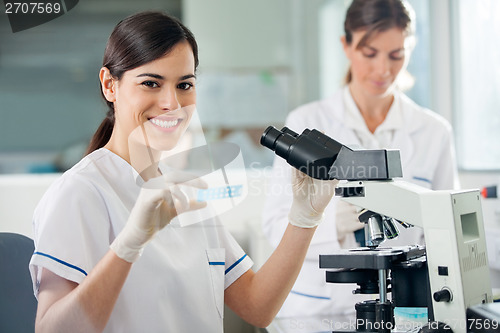 Image of Female Researcher Using Microscope In Lab