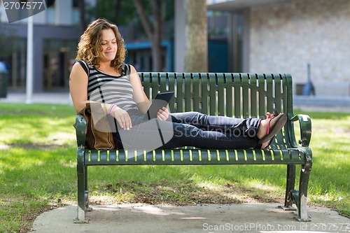 Image of Female University Student Using Digital Tablet On Bench