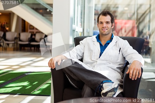 Image of Confident Male Doctor Sitting On Chair