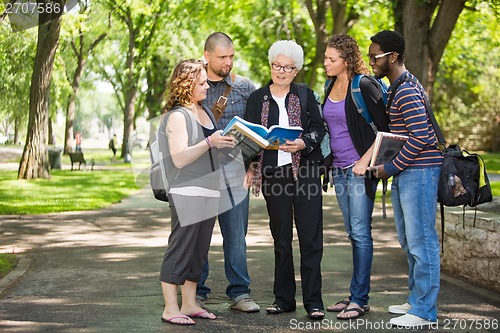 Image of Students Discussing Notes On Campus Road