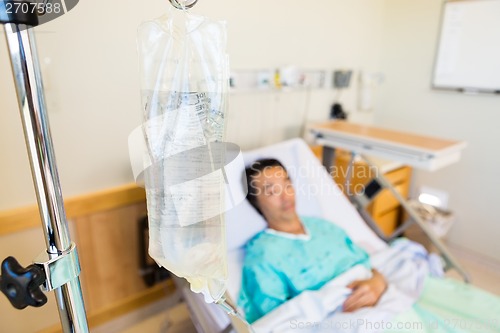 Image of IV Bag With Patient Lying On Hospital Bed